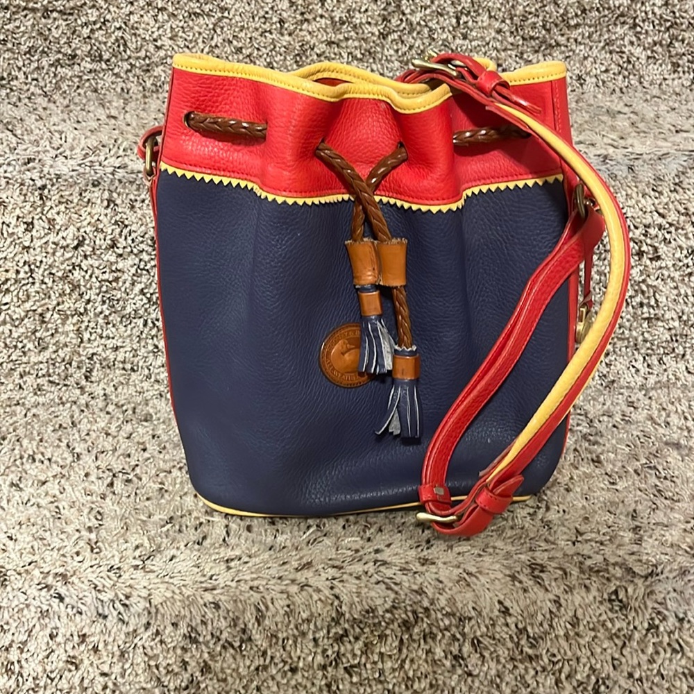 Dooney and Bourke, blue, red trimmed with yellow.  Excellent used condition
